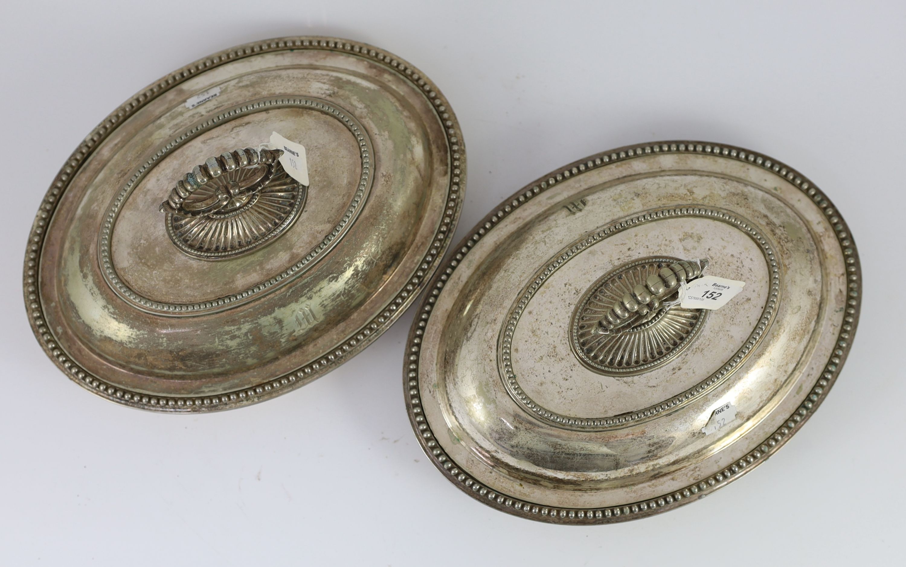 A pair of plated oval entree dishes, covers and detachable handles, 31cm wide